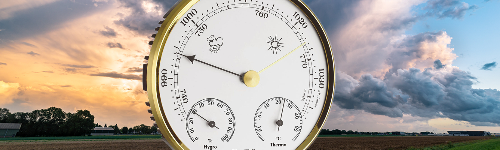Barometer with a scenic background of clouds and fields